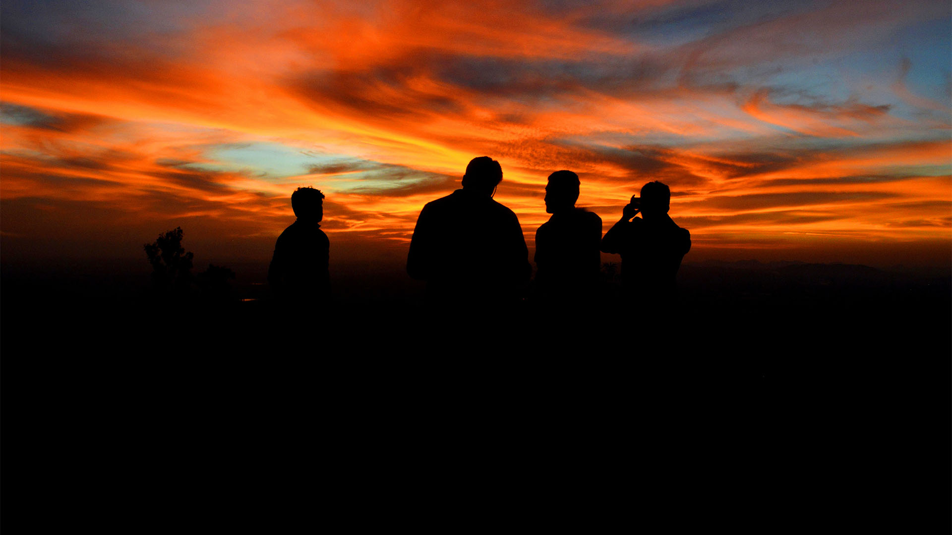 People looking into sunset